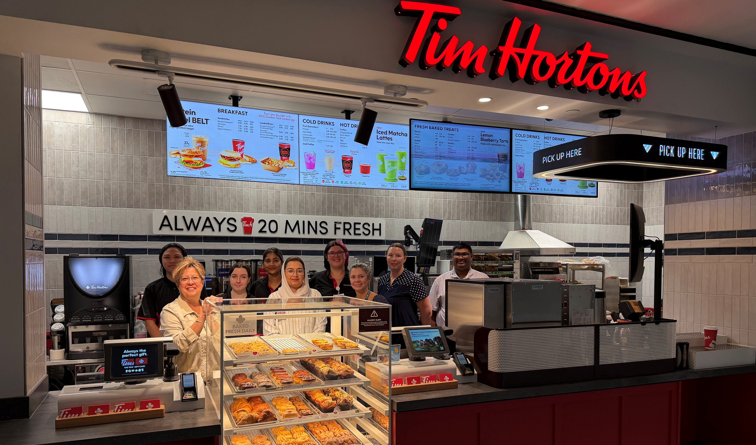 Picture of Aramark staff standing at the refreshed Tim Hortons located in the hospital's cafeteria.